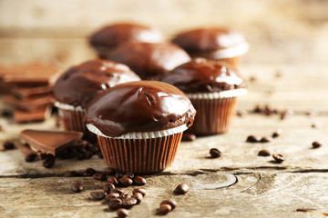 Tasty homemade chocolate muffins on wooden table