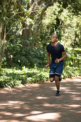 Attractive Black man running, exercising , stretching outside Pa