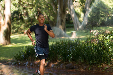 Attractive Black man running, exercising , stretching outside Pa