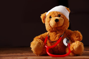 Conceptual Bandaged Teddy Bear with Stethoscope