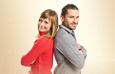 Couple with their arms crossed over isolated background