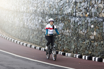 The asian girl cycling