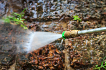 Obraz premium Stone floor cleaning with high pressure water jet