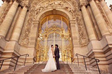 Bride and groom in front of a big building