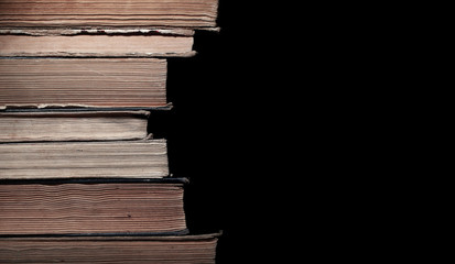Stack of old books isolated on black background