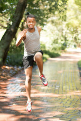 Attractive Black man running, exercising , stretching outside Pa