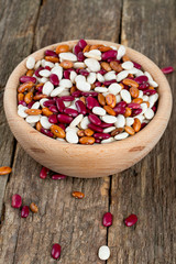 various beans in a wooden bowl