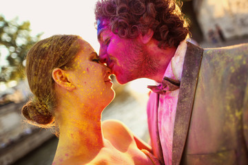 Portrait of a bride and groom having fun with holi powder