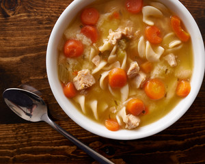 bowl of chicken noodle soup shot top down