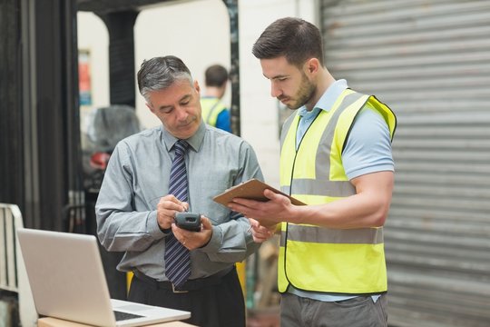 Workers scanning package in warehouse