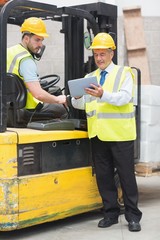 Forklift driver talking with his manager