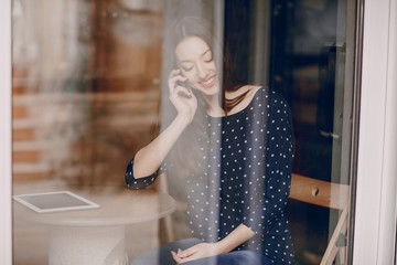 beautiful young girl enjoys phone and tablet