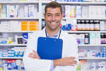 Happy pharmacist holding clipboard