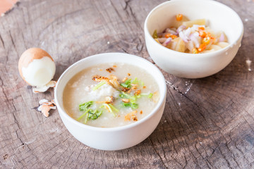 Bowl of oats porridge on wooden table. Healthy breakfast