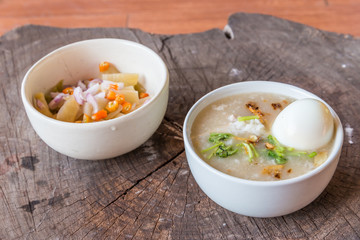 Bowl of oats porridge on wooden table. Healthy breakfast