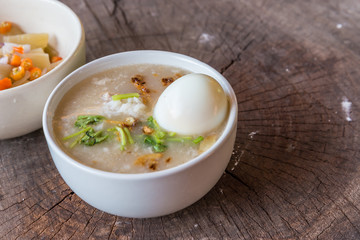 Bowl of oats porridge on wooden table. Healthy breakfast
