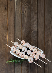 Three skewers with shrimps
