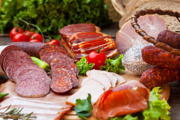 Meat products with tomato and green salad