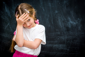 little girl on the background of school board