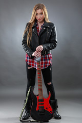 Naklejka premium Beautiful young,blond woman with a electric guitar