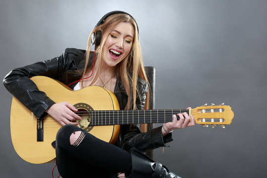 a beautiful young blonde with a classical guitar
