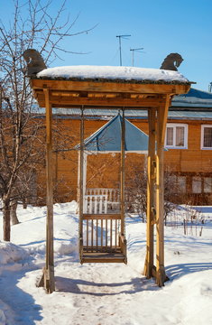 Vintage wooden swings in the winter yard