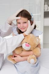 Doctor making plaster in little girl