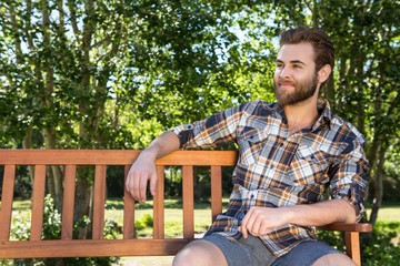 Handsome hipster relaxing in the park