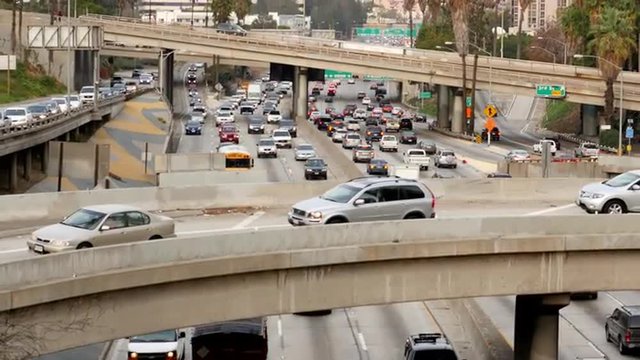 Zoom Out / Overhead View of Traffic on Busy Freeway in Downtown Los Angeles California 