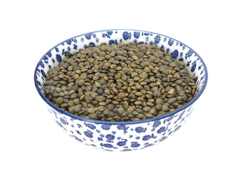 Marbled dark green lentils in a blue and white china bowl