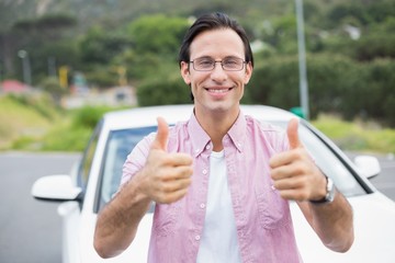 Fototapeta premium Man smiling at camera showing thumbs up