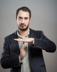 young businessman showing time out sign with hands against - 78833456
