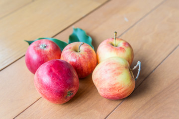 fresh red apples on wooden surface