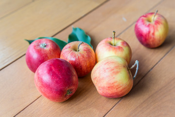 fresh red apples on wooden surface