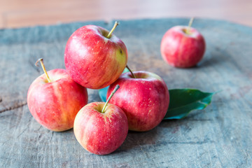 fresh red apples on wooden surface