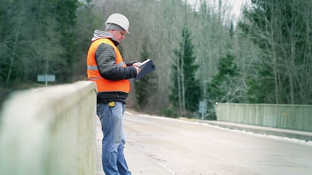 Engineer reading documentation on the bridge