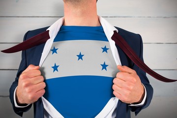 Businessman opening shirt to reveal Honduras flag