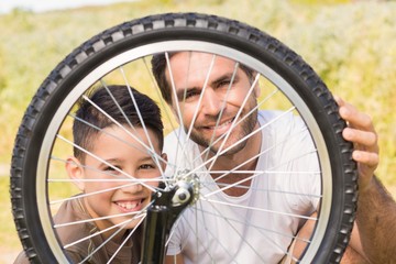 Fototapeta premium Father and son repairing bike together