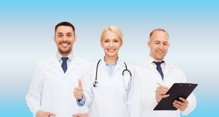 group of doctors showing thumbs up in clinic