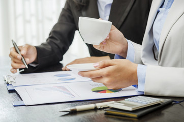Businesswoman drinking coffee in the meeting