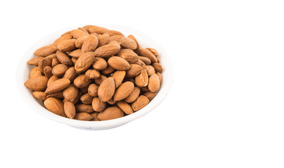Raw almond nut in a white bowl over white background