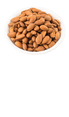 Raw almond nut in a white bowl over white background