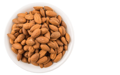 Raw almond nut in a white bowl over white background