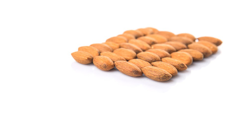 Raw almond nut over white background