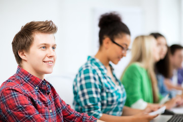 student with computer studying at school