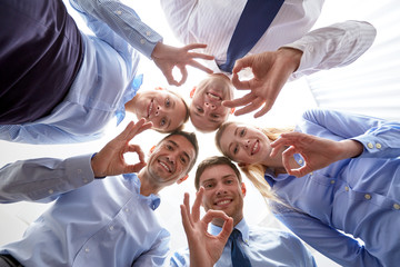 smiling group of businesspeople standing in circle
