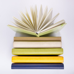 A stack of colorful books, open book. Back to school