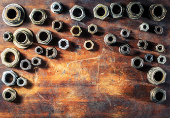 Screws on dirty wooden table