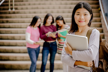 group of happy teen high school students outdoors