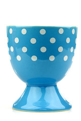 colorful and decorated blue and white egg cup on a white backgro